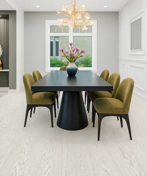 Bright Dining Space Featuring Swiss Snow Cap Real Wood Floating Flooring With A Matte White-Washed Finish, Paired With A Black Modern Table And Green Upholstered Chairs.