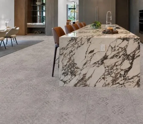 Vintage Stone - 19/64&Quot; (7.5Mm) - Swiss Techslate (Mvinst7.5) Vintage Stone Swiss Techslate Gray Stone-Look Floating Flooring In An Open-Concept Luxury Kitchen With Marble Island.