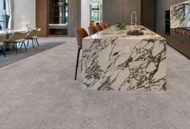Vintage Stone - 19/64&Quot; (7.5Mm) - Swiss Techslate (Mvinst7.5) Vintage Stone Swiss Techslate Gray Stone-Look Floating Flooring In An Open-Concept Luxury Kitchen With Marble Island.