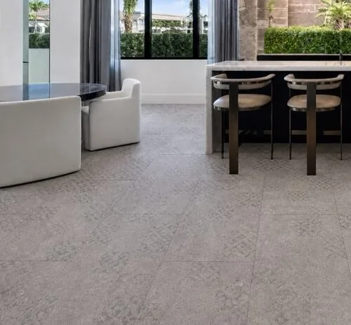 Vintage Stone - 19/64&Quot; (7.5Mm) - Swiss Techslate (Mvinst7.5) Vintage Stone Swiss Techslate Gray Stone-Look Floating Flooring In An Open-Concept Luxury Kitchen With Marble Island.