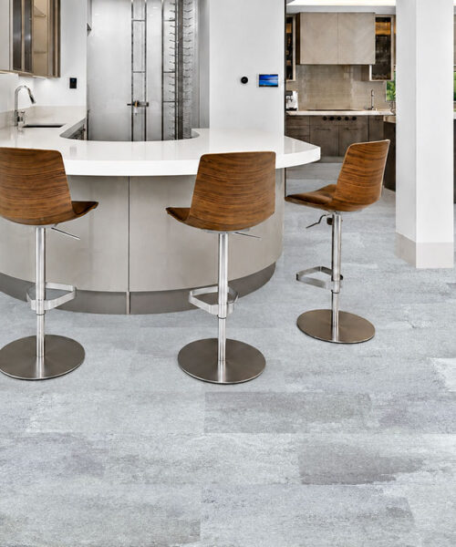 Warm Stone - 7/16&Quot; (11Mm) - Swiss Design Cork Floating (Fwmst11) Warm Stone Gray Floating Cork Flooring With A Mineral Pattern Surrounds A Curved Kitchen Bar And Wood Stools.