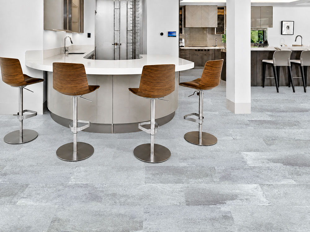 Warm Stone - 7/16&Quot; (11Mm) - Swiss Design Cork Floating (Fwmst11) Warm Stone Gray Floating Cork Flooring With A Mineral Pattern Surrounds A Curved Kitchen Bar And Wood Stools.