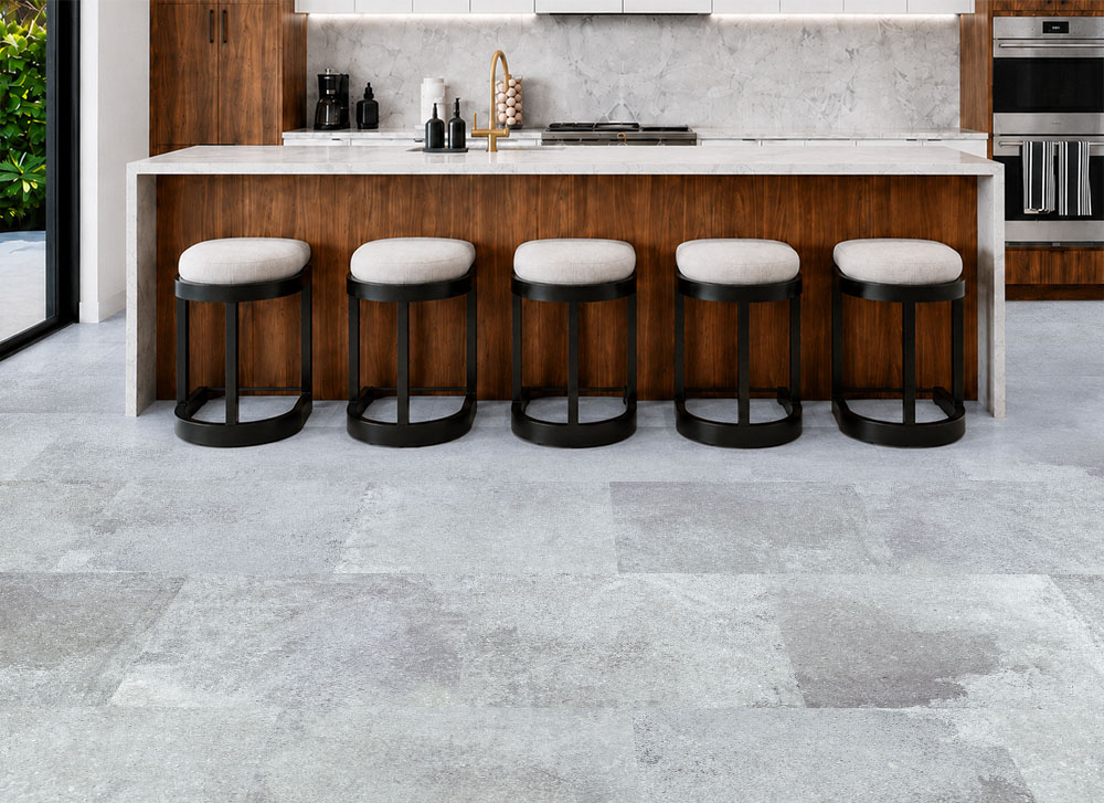 Warm Stone - 7/16&Quot; (11Mm) - Swiss Design Cork Floating (Fwmst11) Warm Stone Light Gray Stone-Look Cork Planks Extend Across A Walnut Kitchen With A Marble Island And Stools.