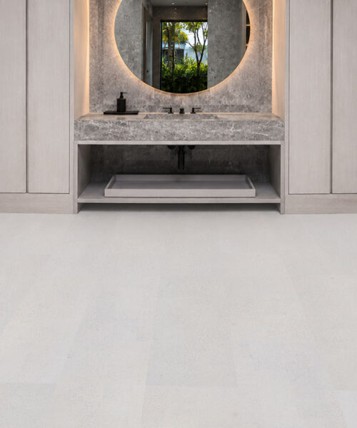 White Leather cork flooring in a luxury modern bathroom with floating vanity, marble countertop, and seamless white cork planks.