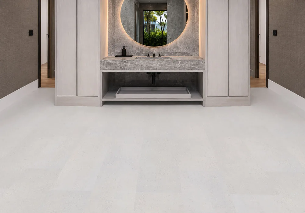 White Leather Cork Flooring In A Luxury Modern Bathroom With Floating Vanity, Marble Countertop, And Seamless White Cork Planks.