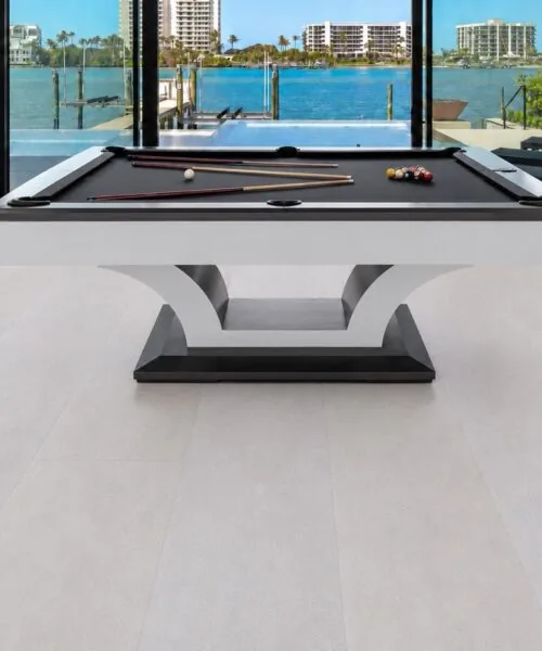 White Leather - 1/2&Quot; (12Mm) - Cork Floating (Fwl12) White Leather Cork Flooring Installed In A Modern Game Room With A Pool Table, Large Windows, And Seamless White Cork Plank Flooring.