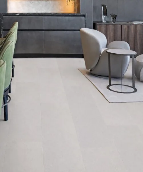White Leather 12mm cork floating flooring installed in a modern luxury lounge with green velvet bar stools and seamless white cork planks.