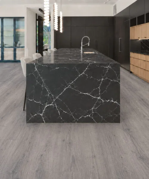 Wild Oak - 13/32&Quot; (10.5Mm) - Design Cork Floating (Fwo10.5) Wild Oak Gray Oak-Look Cork Flooring In A Modern Kitchen With A Black Marble Island.