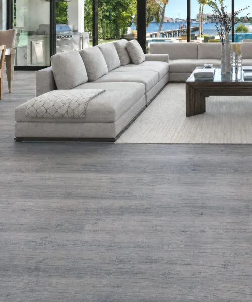 Wild Oak gray cork floating flooring with wide oak-look planks in an open-plan living room.