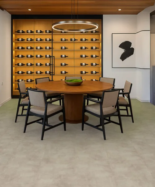Copperstone Gray Natural Composite Flooring Adds A Subtle Stone-Look Surface To A Dining Room With Illuminated Wine Storage.