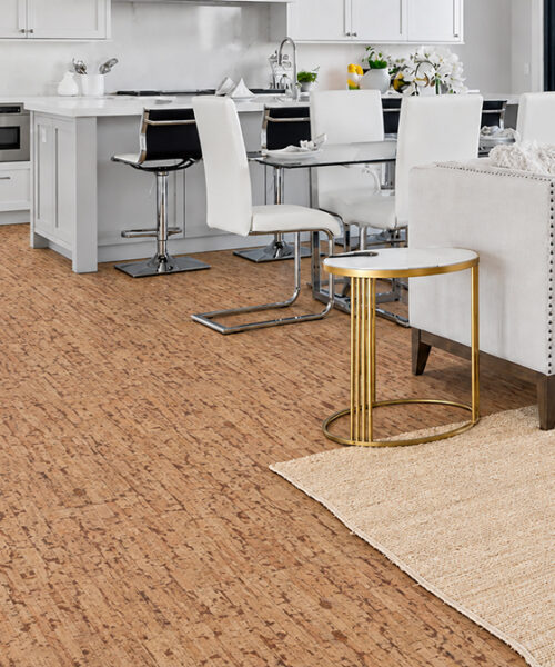 Woodflow Floating Cork Flooring In Natural Brown Connects A White Open Kitchen And Coastal Living Room.